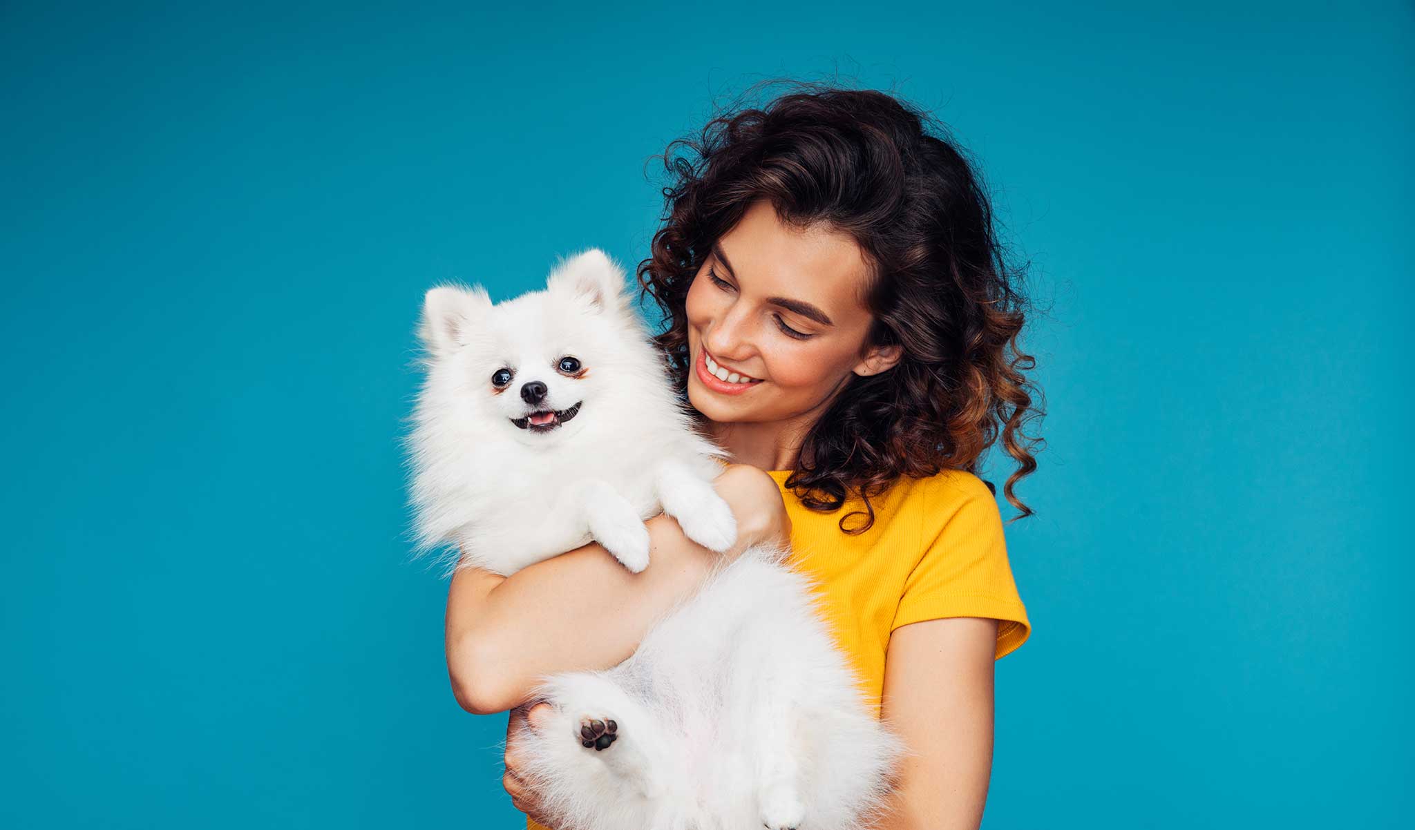 A woman with a white Pomeranian